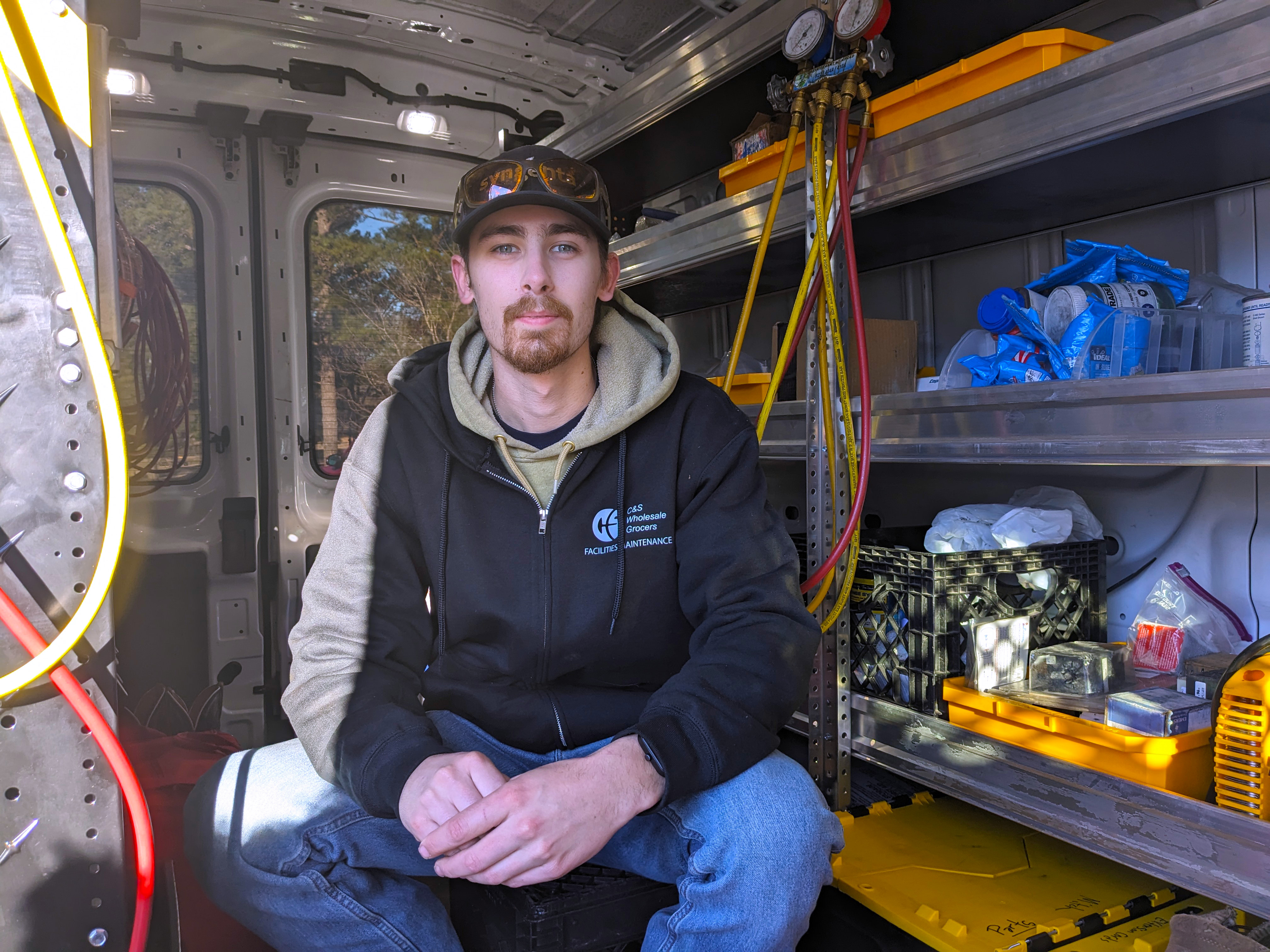 Mitchell Paul sits inside his service van.