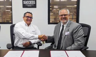 Latham Pools plant manager and RichmondCC president shake hands.