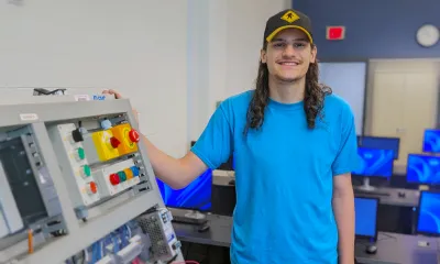 Constantine Amoroso stands in the Mechatronics lab.