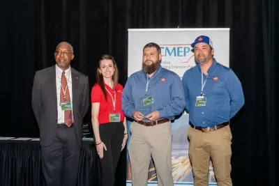 We Pack officials receiving award.