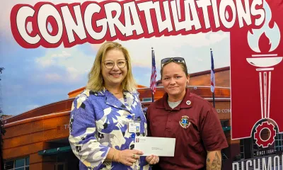 EMT graduate accepts award