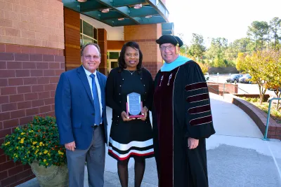Dr. VanRiel stands with college leaders