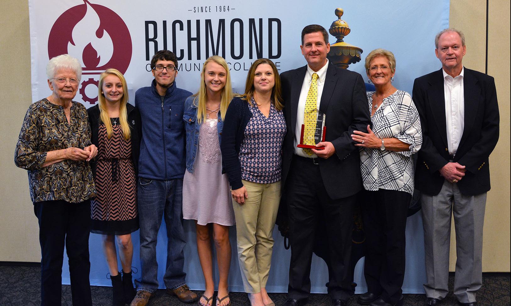 Brett Deaton stands with his family